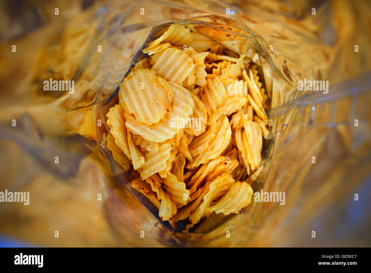 Looking into a half empty bag of potato crisps Stock Photo Alamy