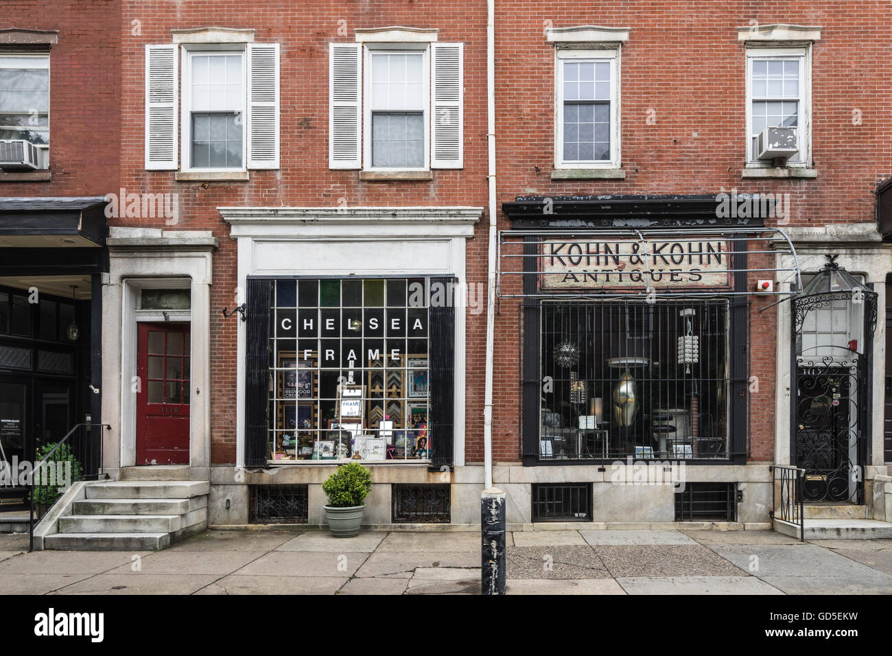 Two traditional brick and mortar stores with old-fashioned window displays along Antique Row on Pine Street in Philadelphia Stock Photo