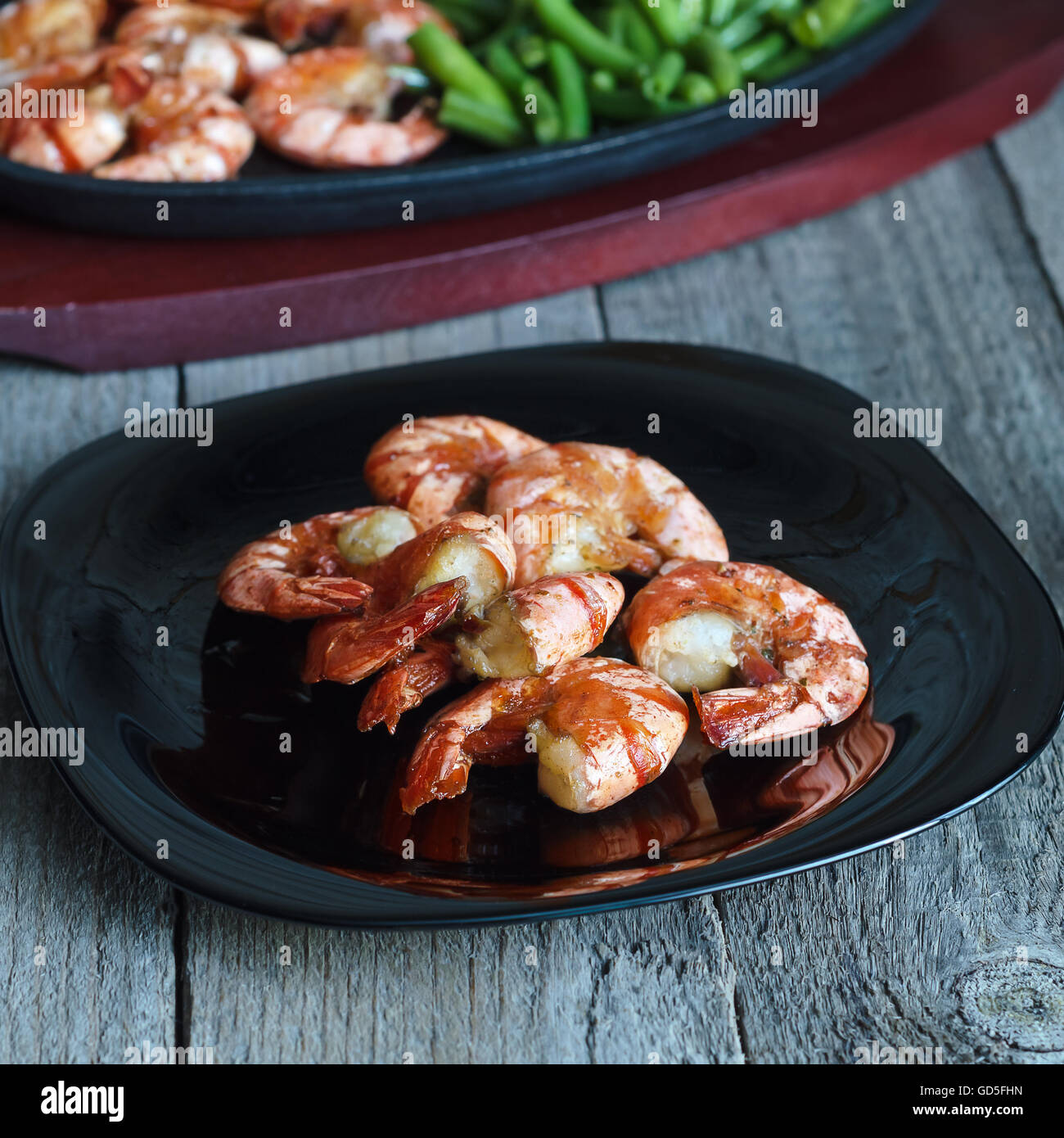 Dish with fried shrimp and green beans Stock Photo