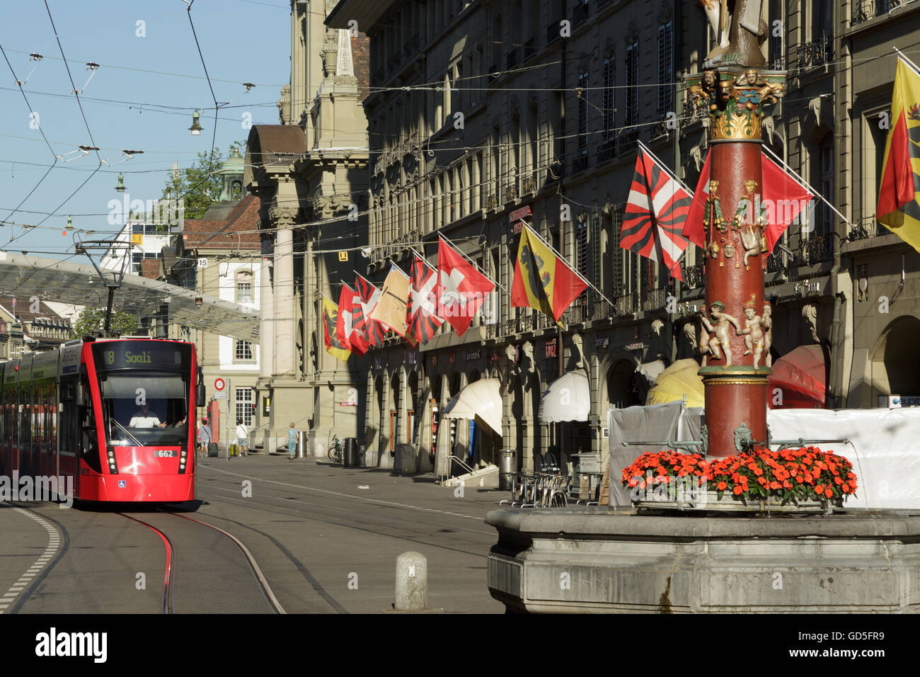 A photograph of a red tram near the main train station in Bern, Switzerland. Stock Photo