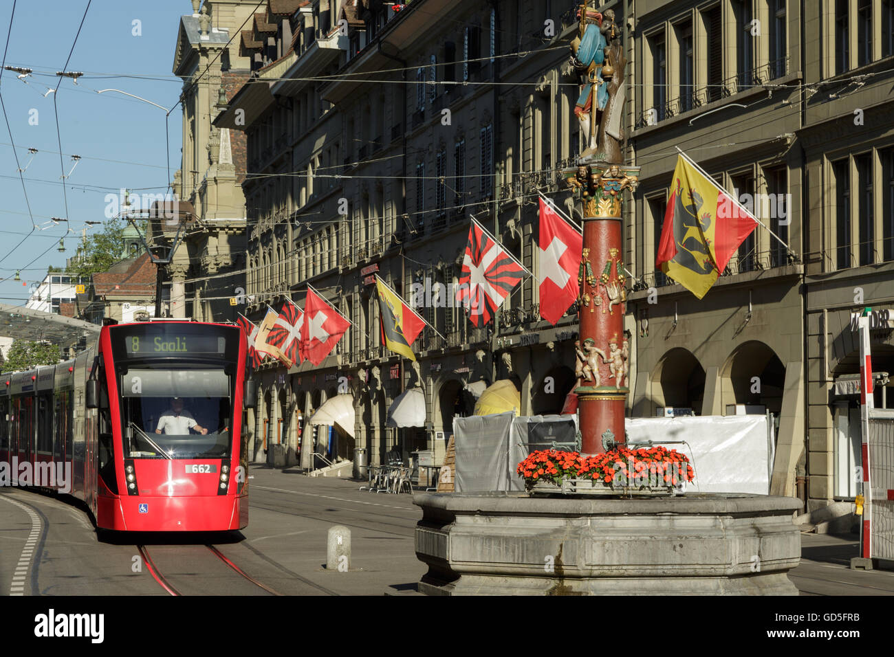 A photograph of a red tram near the main train station in Bern, Switzerland. Stock Photo