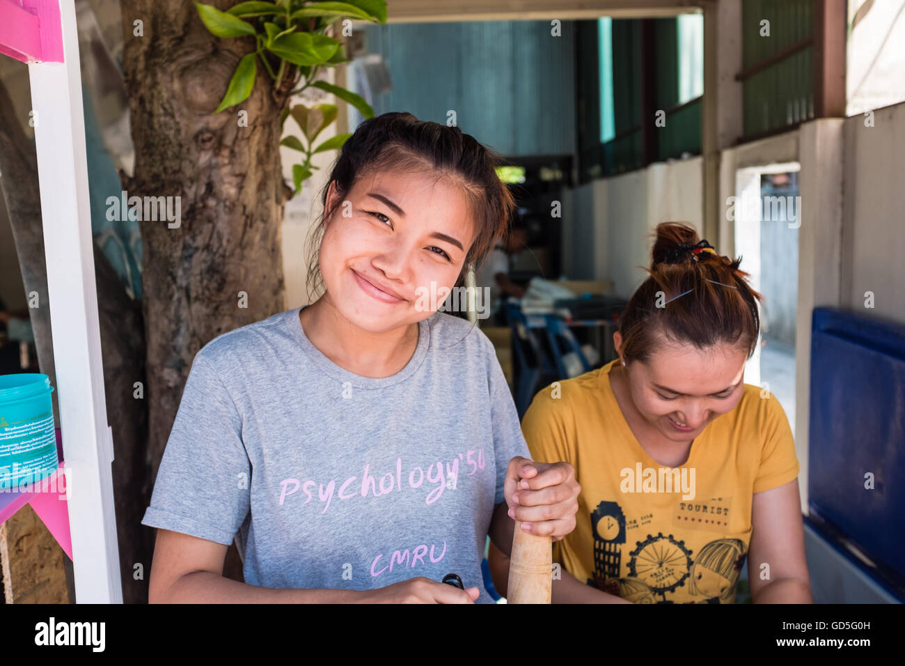 Two young Thai girls making papaya salad,Chiang Mai Thailand Stock Photo