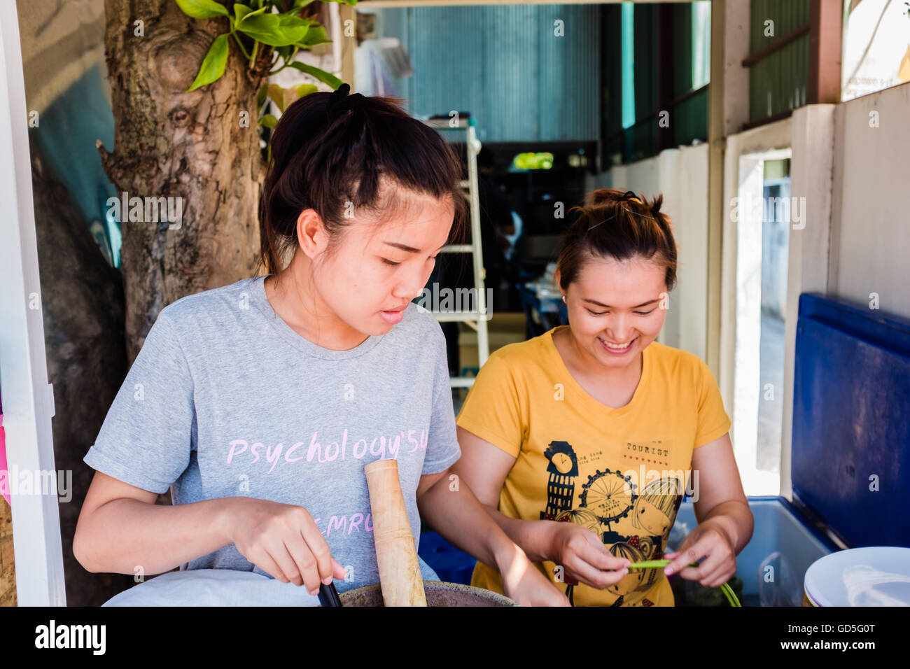 Two young Thai girls making papaya salad,Chiang Mai Thailand Stock Photo