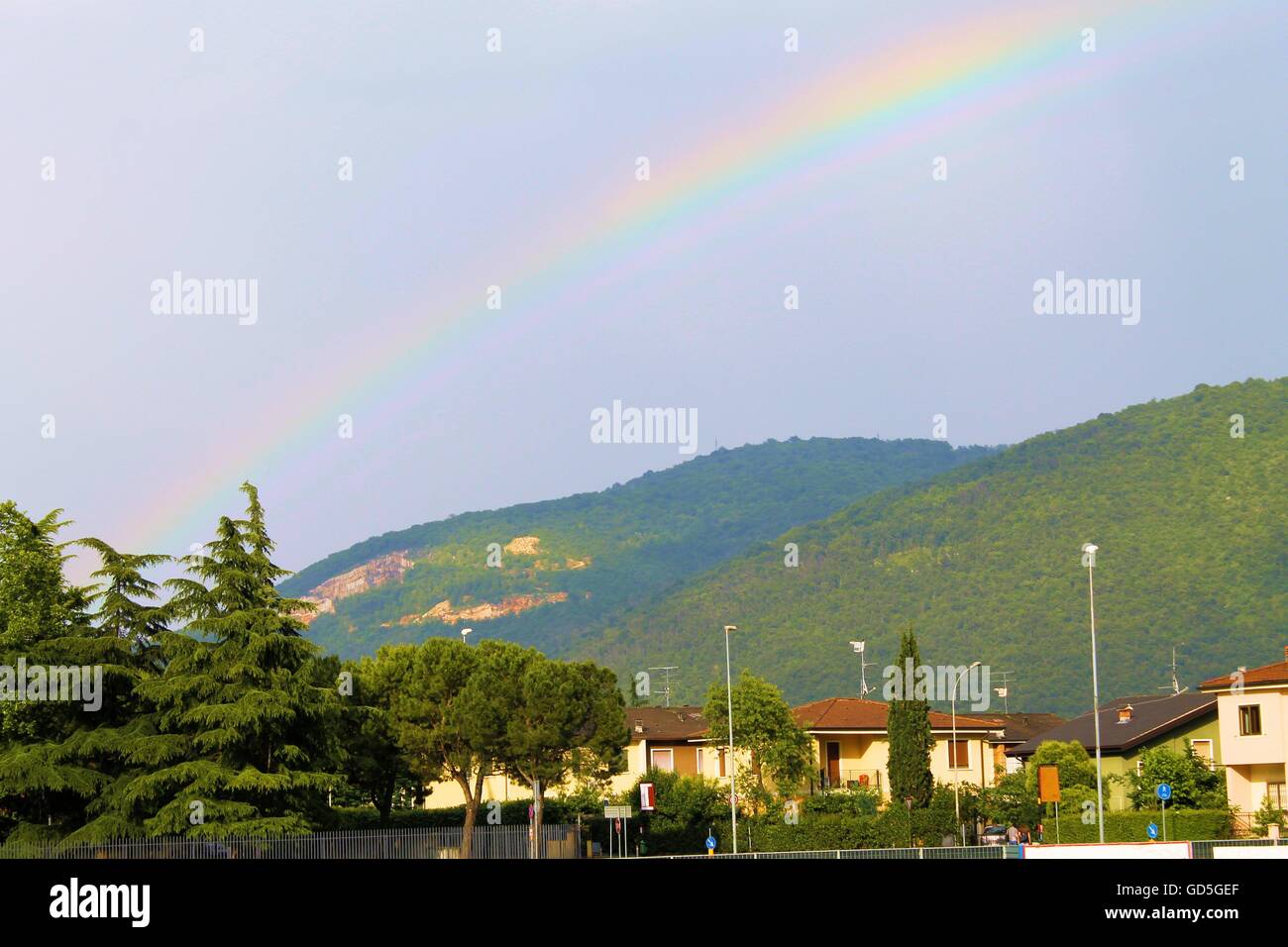 Sky with rainbow and mountains background Stock Photo