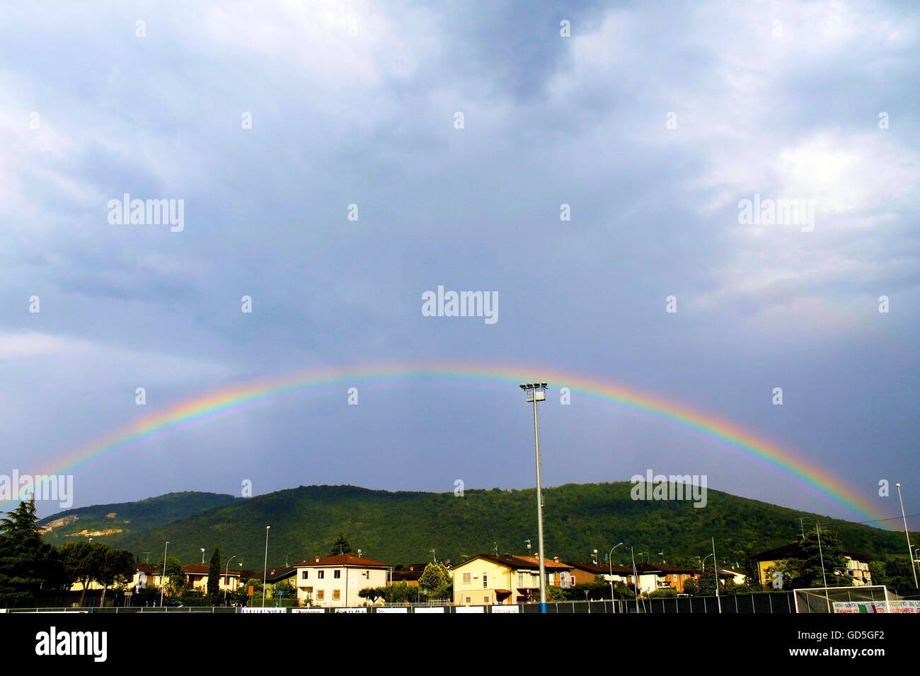 Sky with rainbow and mountains background Stock Photo