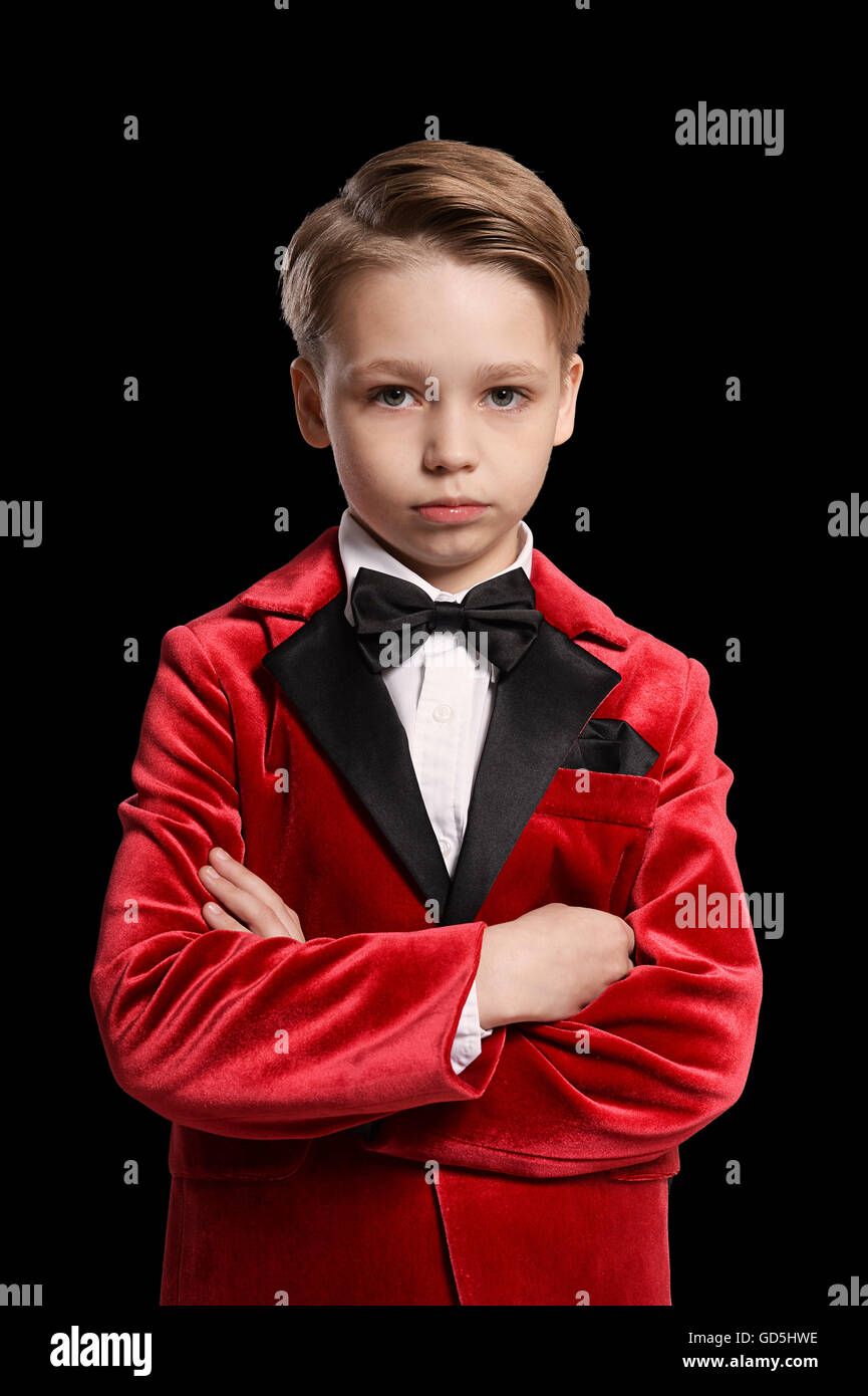 serious little boy in a tuxedo Stock Photo Alamy