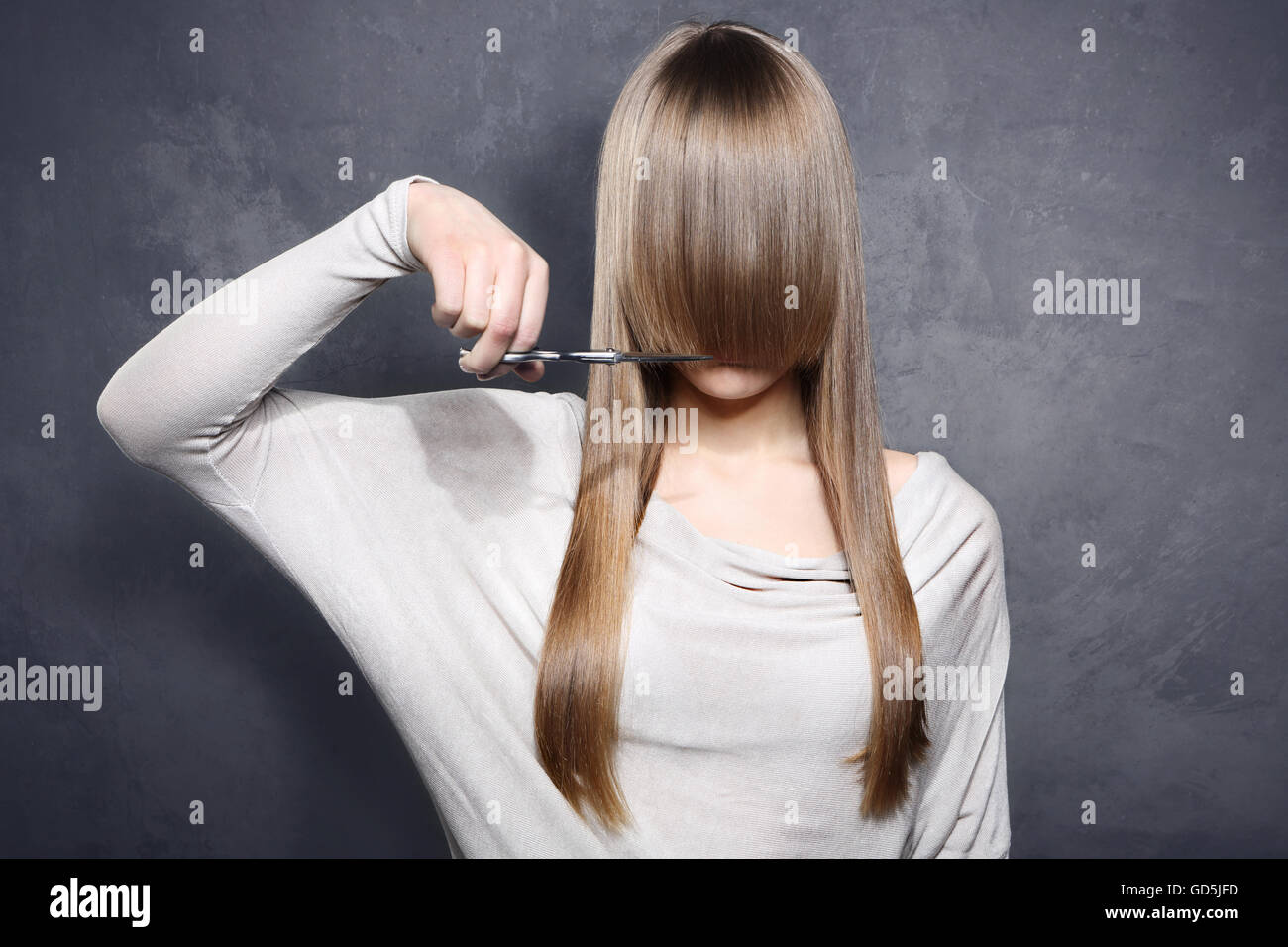 Lovely girl decided to get a haircut Stock Photo