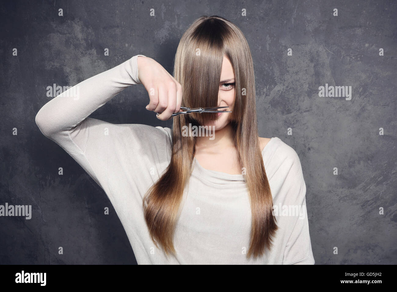 Lovely girl decided to get a haircut Stock Photo