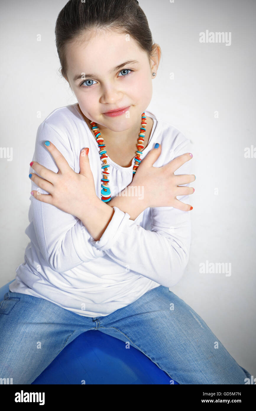 Portrait of smiling little girl with crossed arms Stock Photo - Alamy