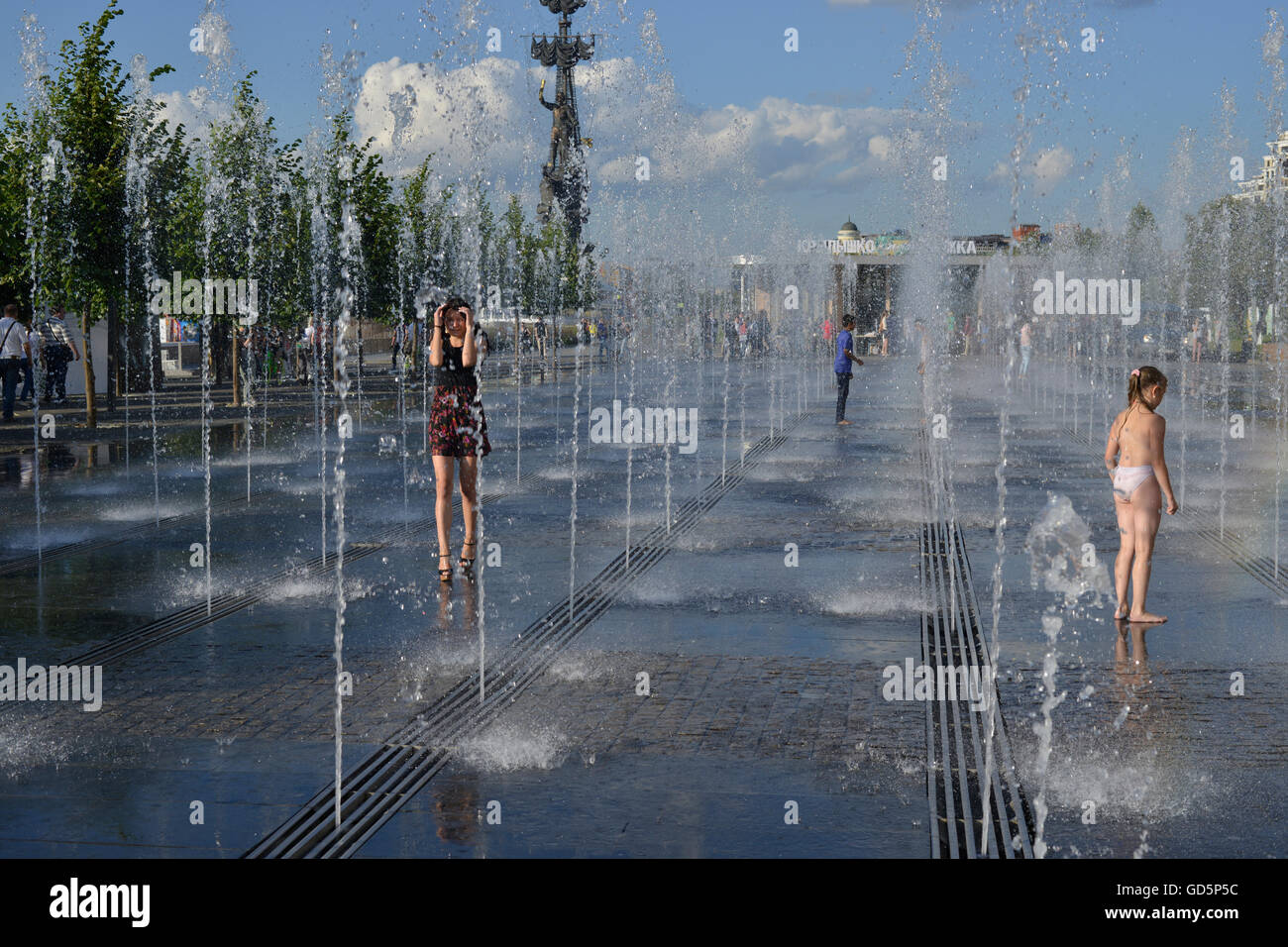 A girl passes through the fountain in Gorky Park in Moscow Stock Photo