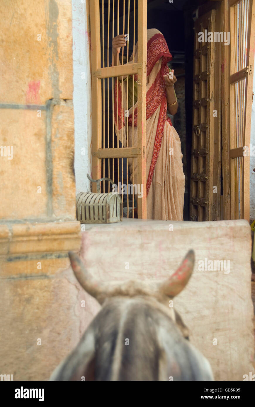 Woman standing next to a door Stock Photo