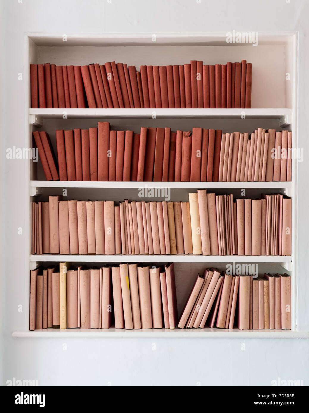 First edition French books covered in pink and red dust wrappers Stock Photo