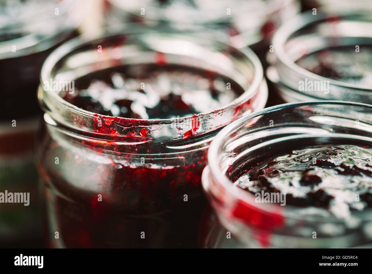 Close Up View Of Jars With Sweet Tasty Yummy Red Jam Stock Photo
