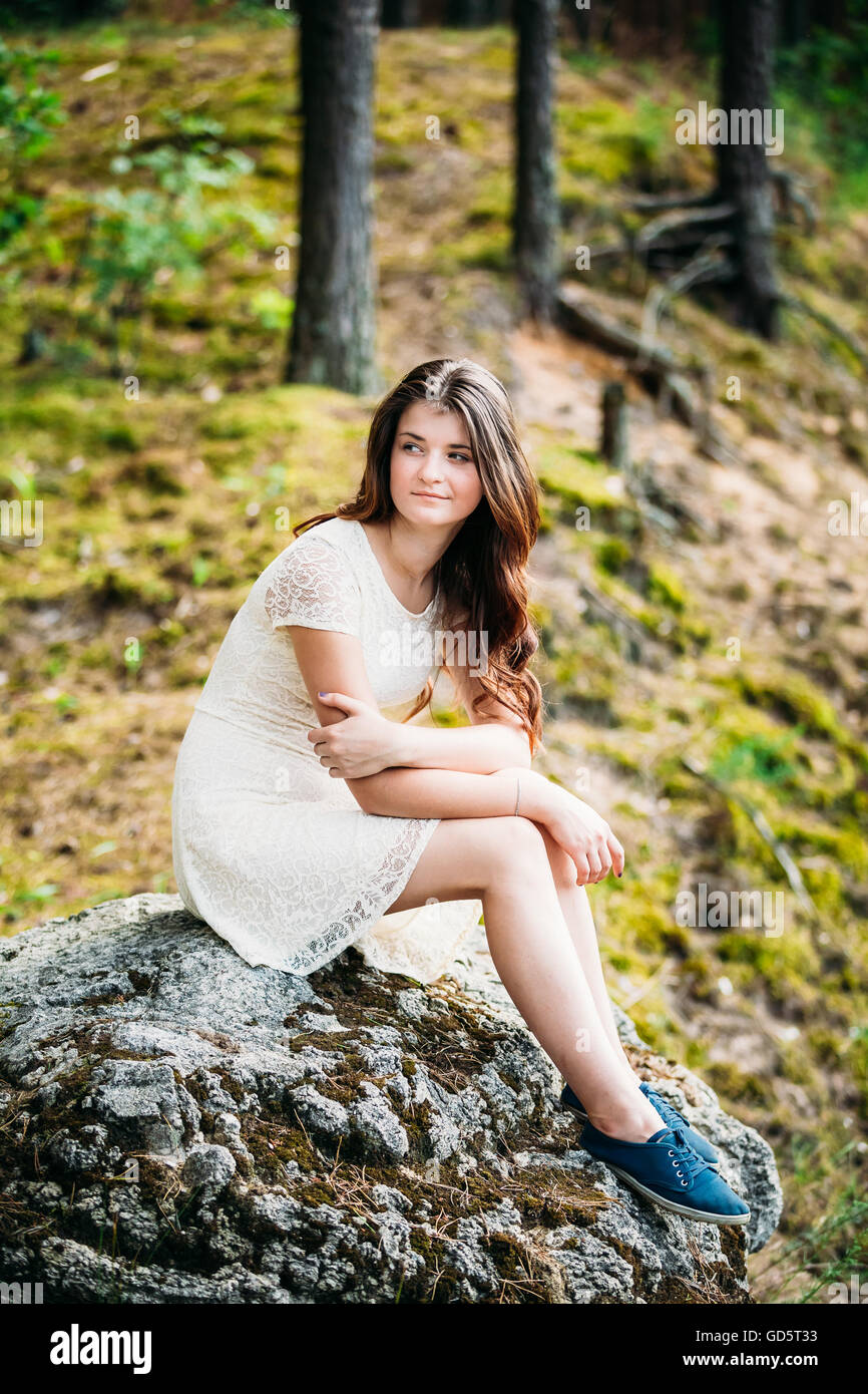 Beautiful Cute Young Smiling Woman Girl In White Dress Sitting On Stone ...