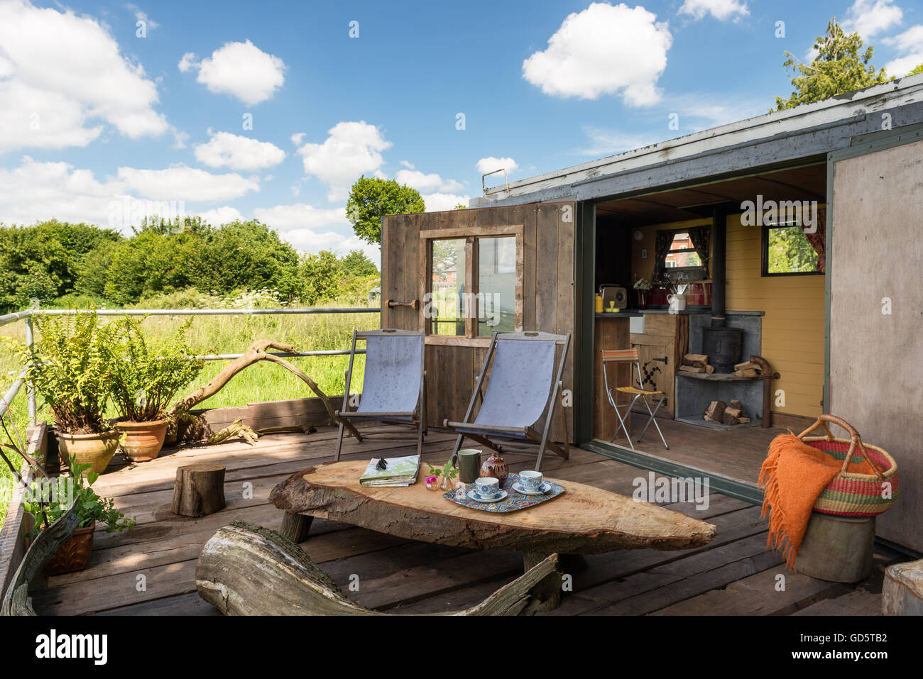 Upcycled decking area of converted military van with deck chairs and
