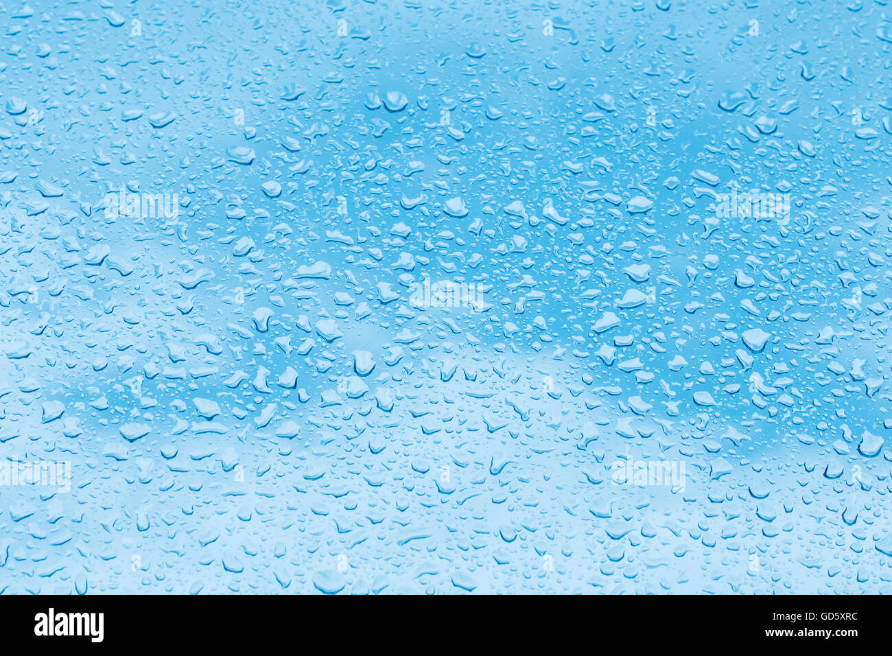 Water drops on blue background, raindrops over glass Stock Photo - Alamy