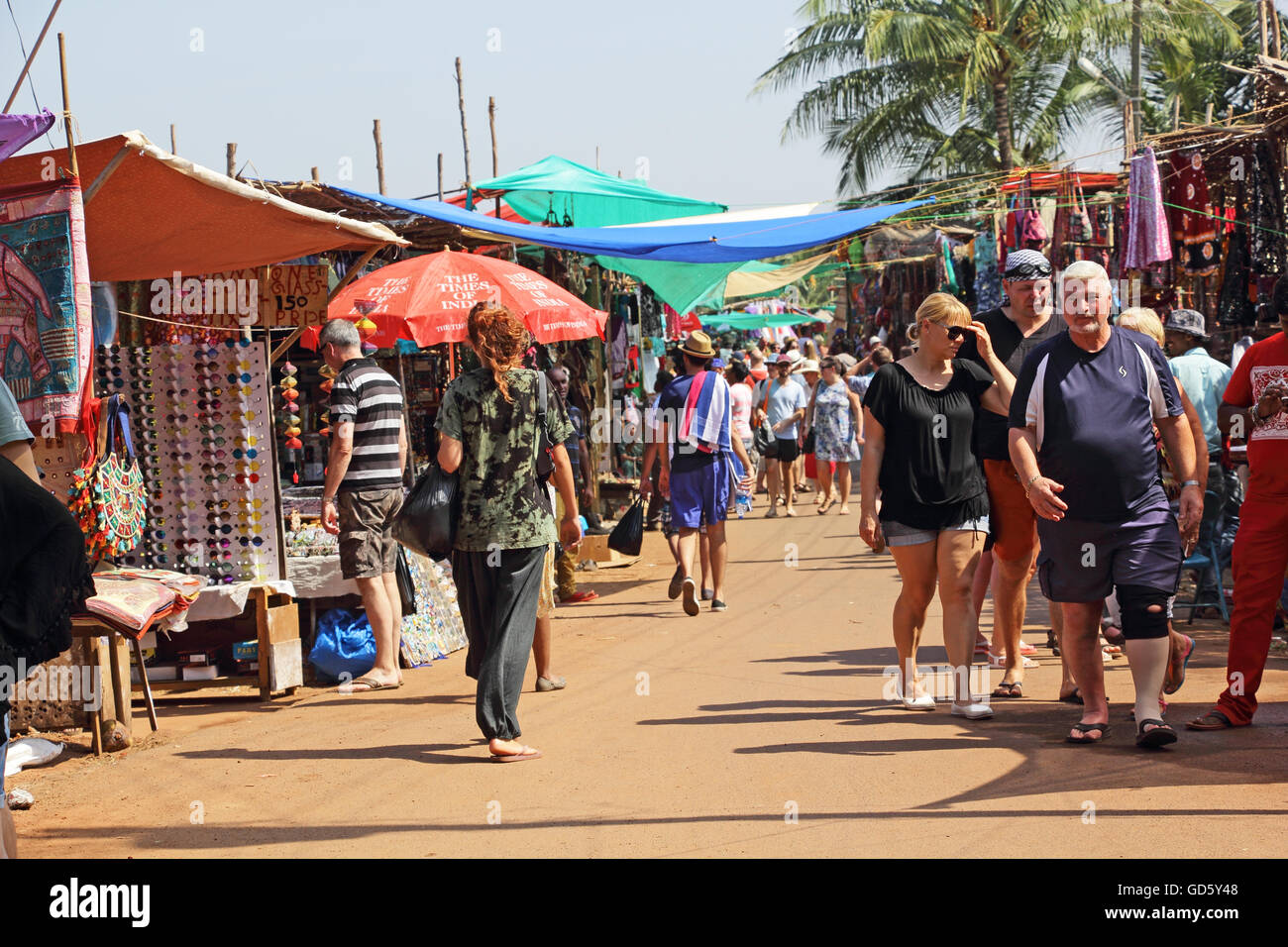 Shoppers at the Wednesday flea market in Anjuna Beach, Goa, India, looking for varieties of merchandise. Stock Photo