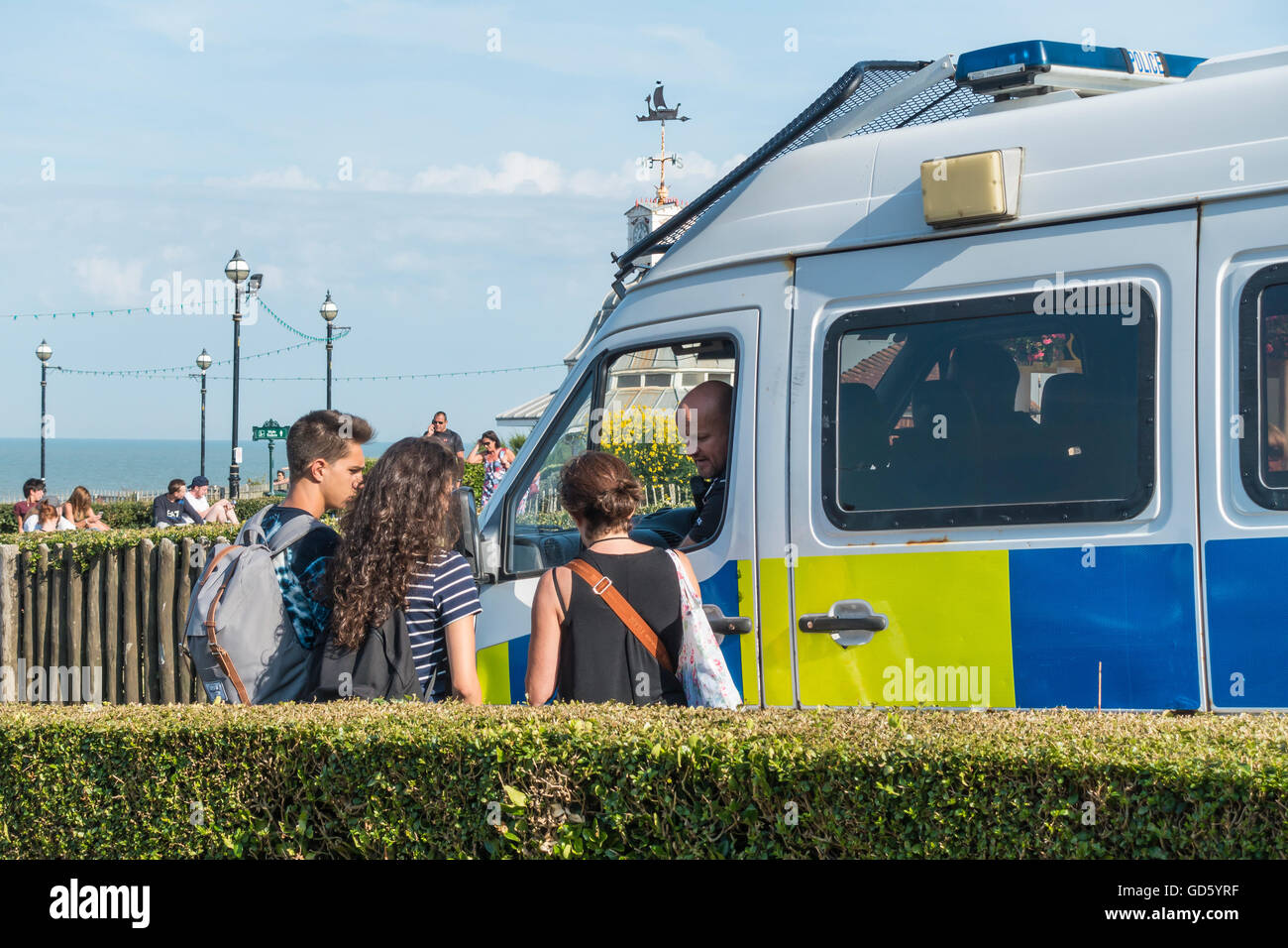 Police Speaking to Teenagers on Seafront Stock Photo