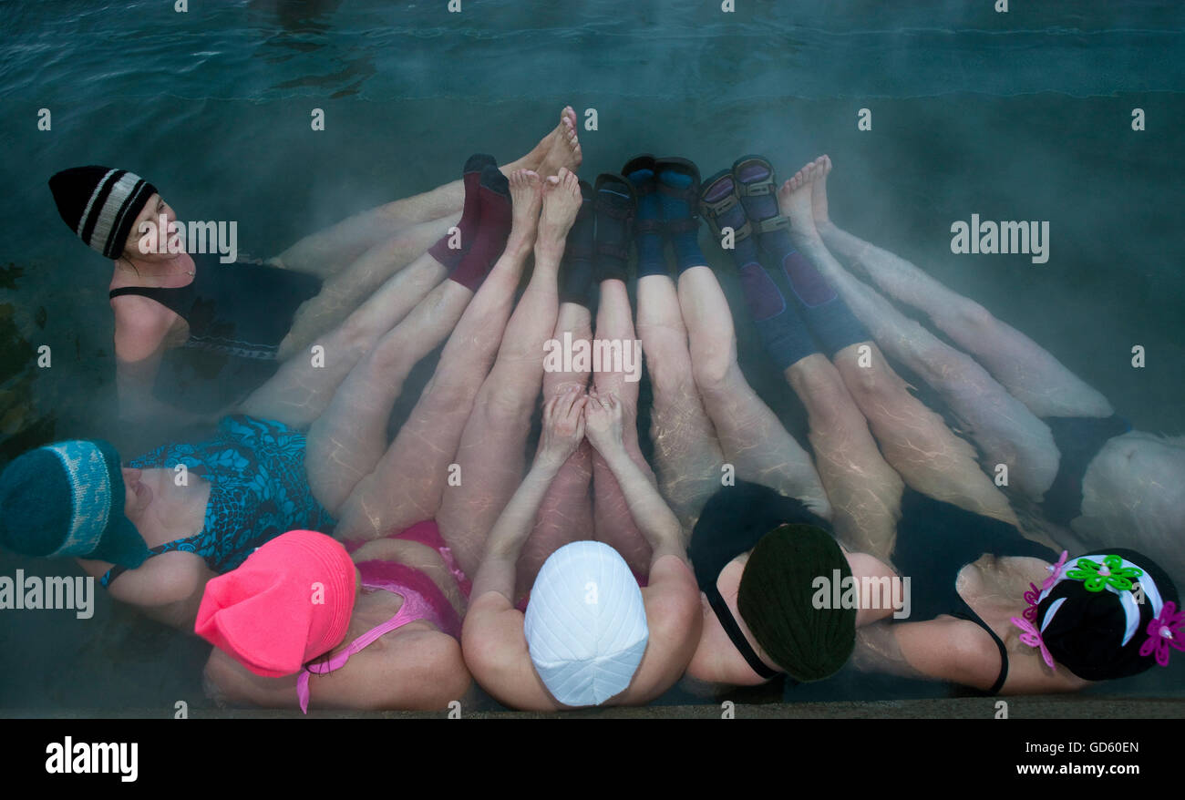 Women enjoying a geothermal heated hot tub outside in the winter, Iceland Stock Photo