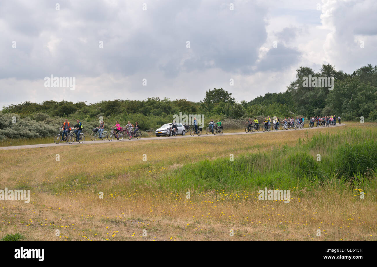 A group of children cycling to a campsite in Lauwersoog, De Marne, Holland, Europe Stock Photo