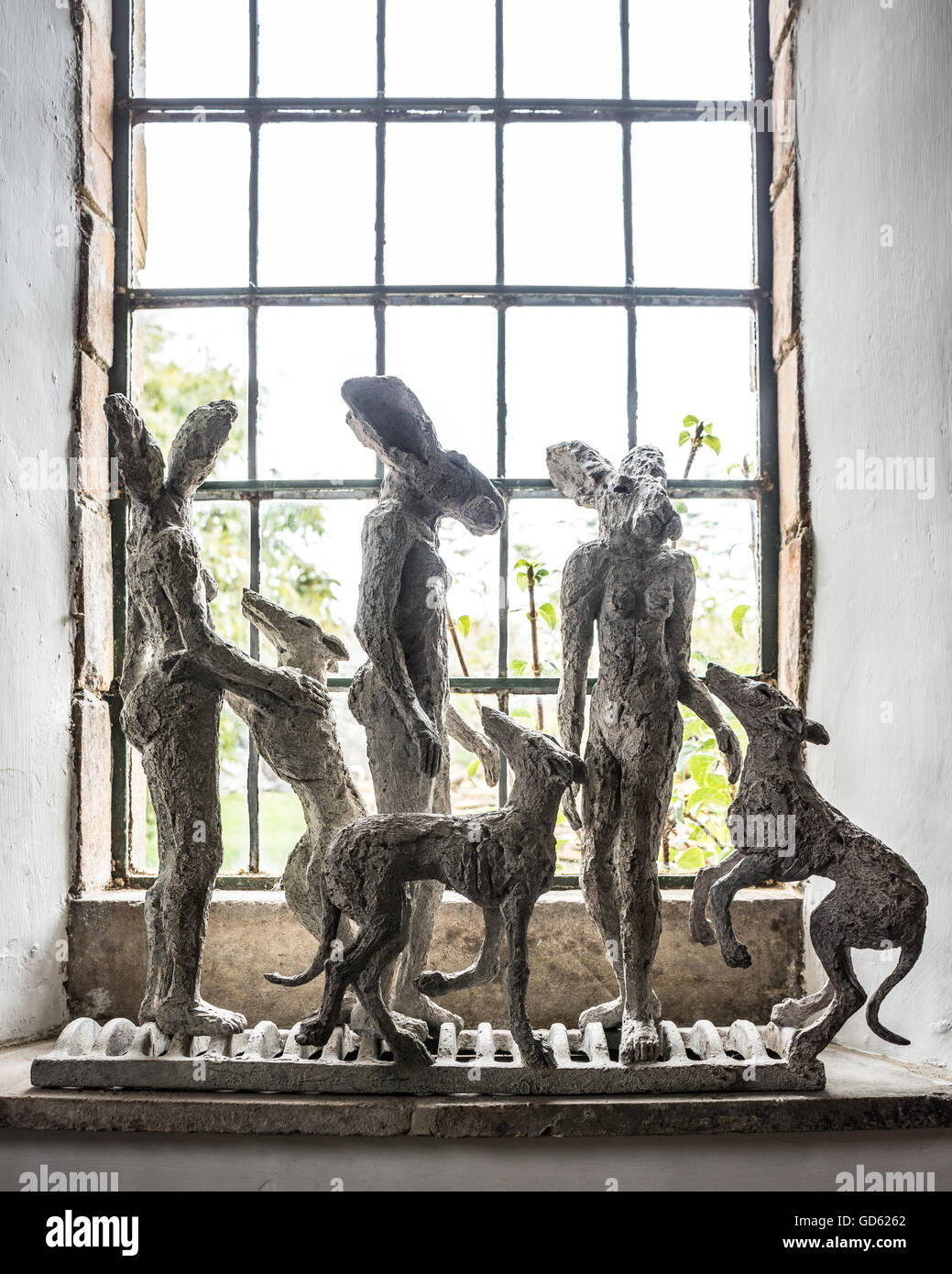 Small Lady-Hare and lurcher maquettes by sophie Ryder on window sill Stock Photo