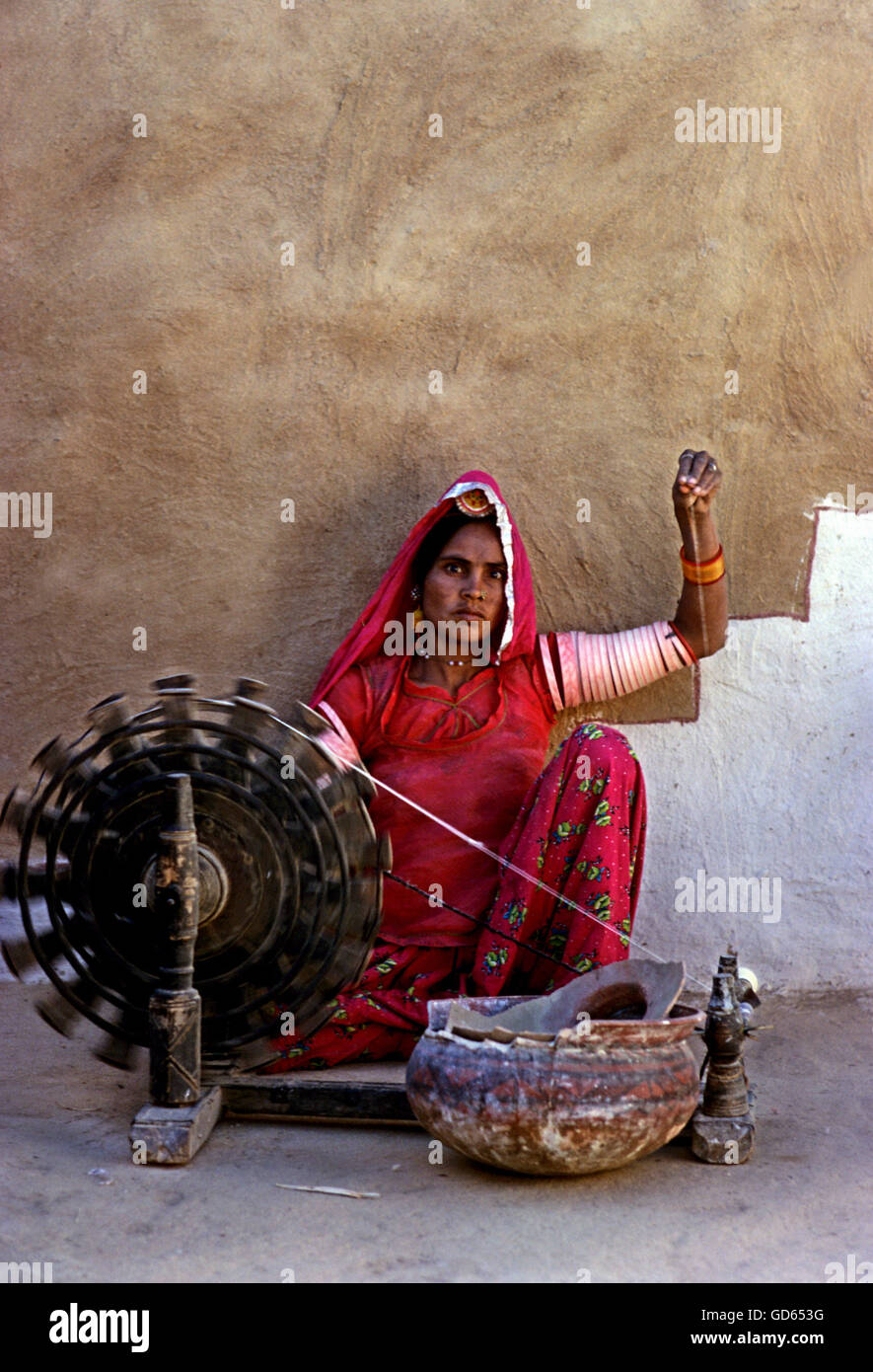 Woman and spinning wheel Stock Photo
