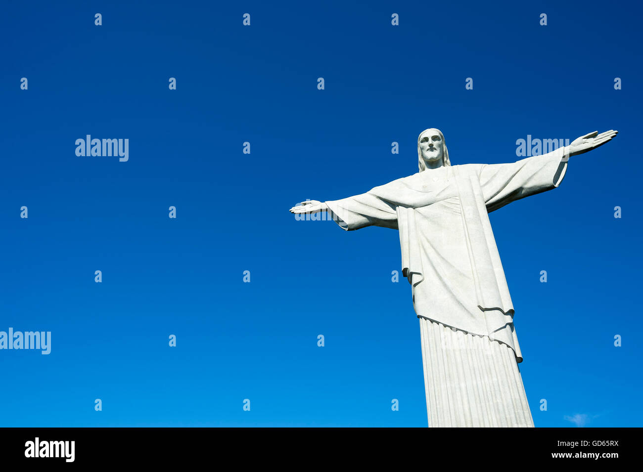 RIO DE JANEIRO - MARCH 05, 2016: Statue of Christ the Redeemer stands in clear blue sky in bright morning sun. Stock Photo
