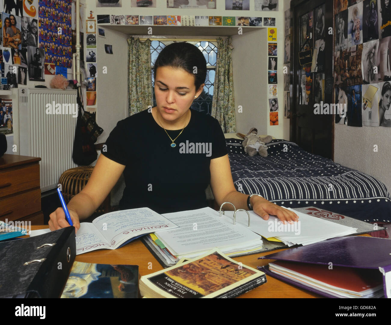 Boarding school student studying in her bedroom. England. UK Stock Photo