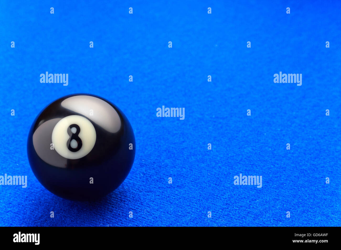 Eight billiard ball in a blue pool table. Stock Photo