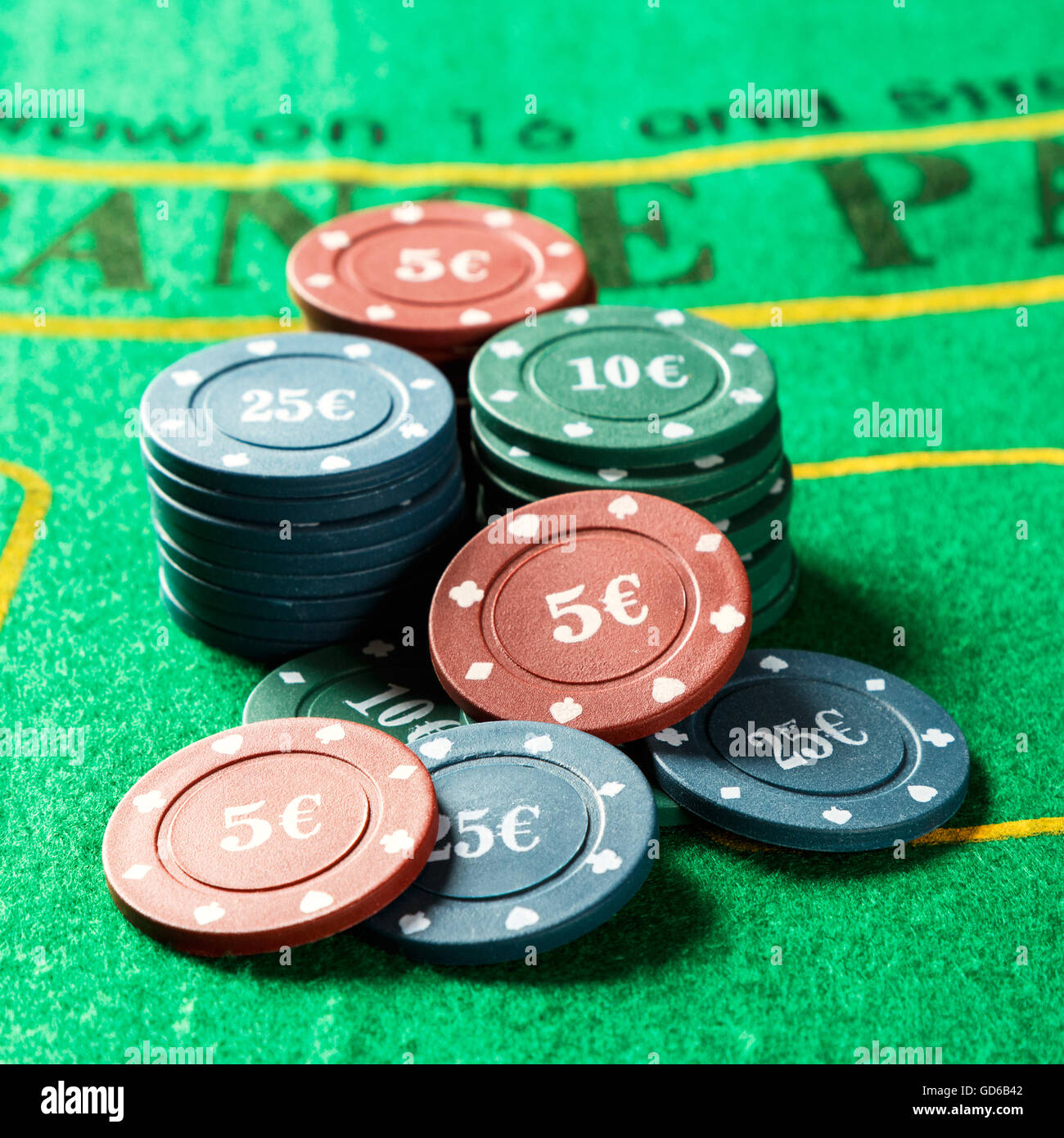 Poker chips on a poker table. Square image close-up Stock Photo - Alamy