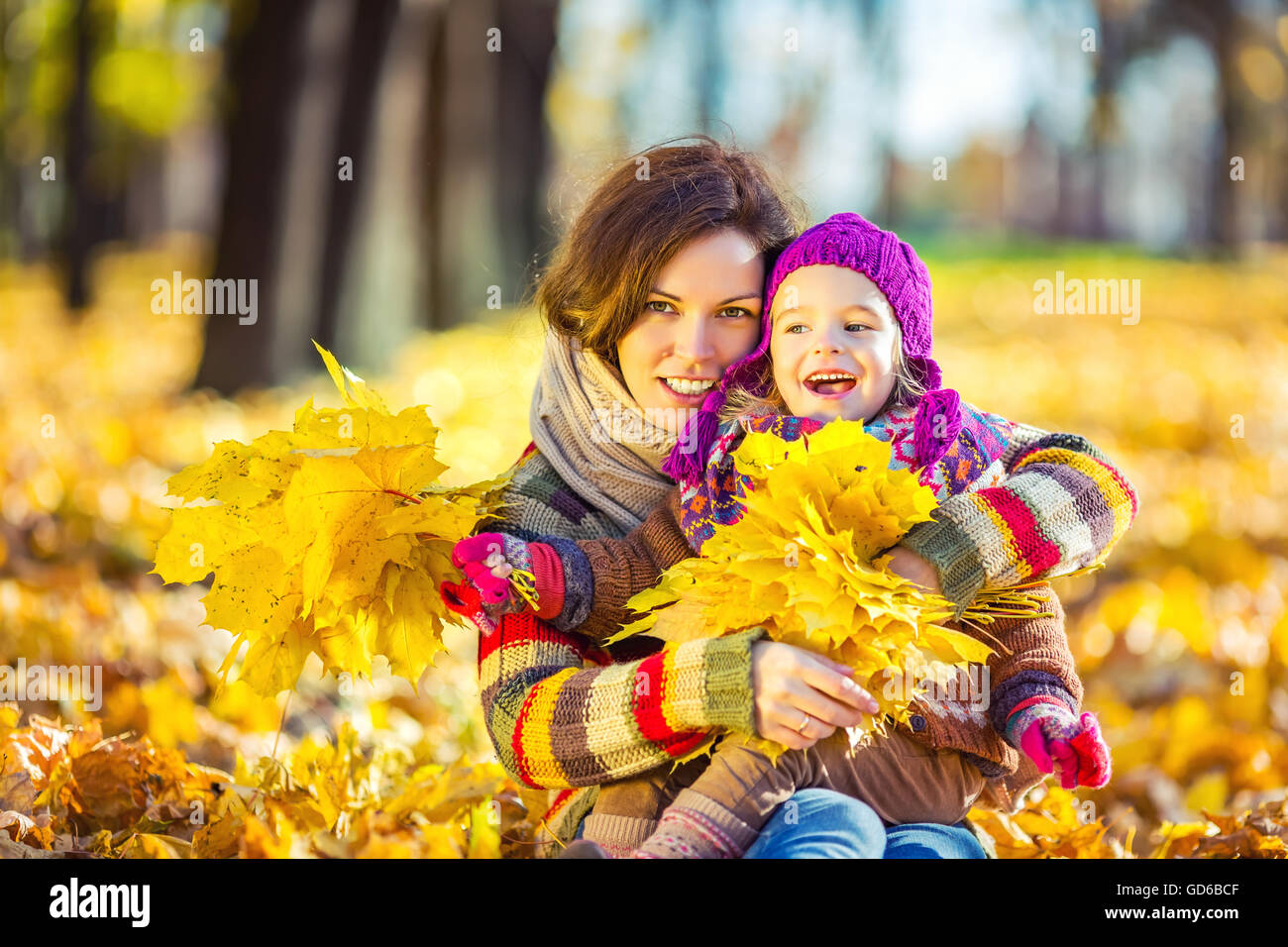 Mother and daughter in playing in autumn park Stock Photo - Alamy
