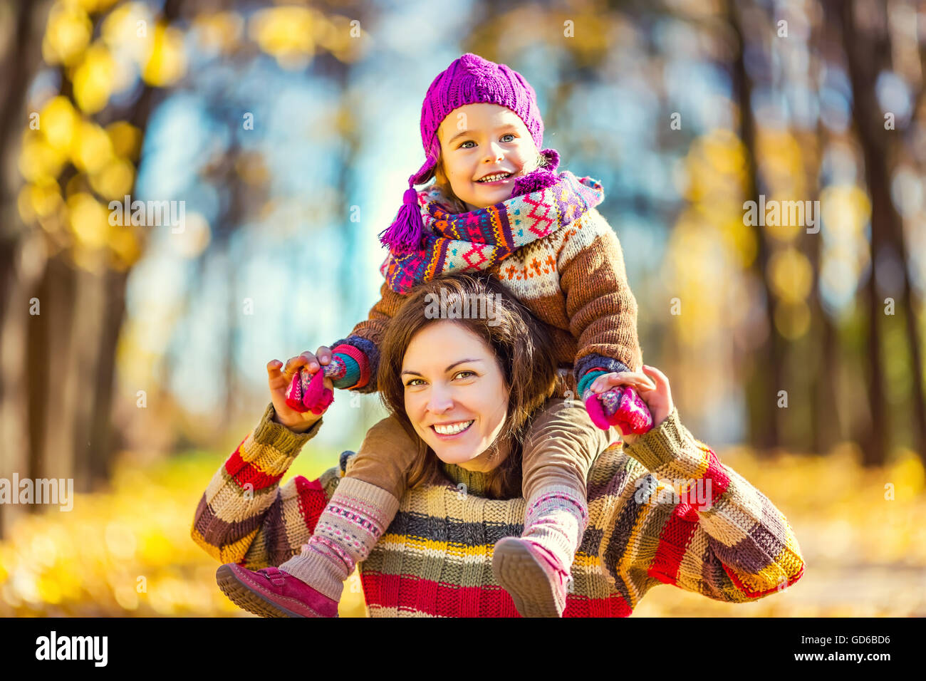 Mother and daughter in playing in autumn park Stock Photo - Alamy