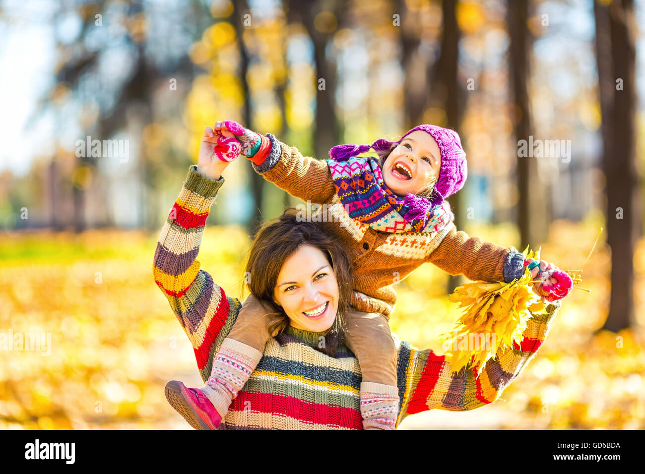 Mother and daughter in playing in autumn park Stock Photo - Alamy