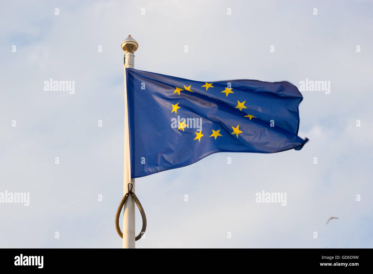 European union flag waving on blue sky background Stock Photo - Alamy
