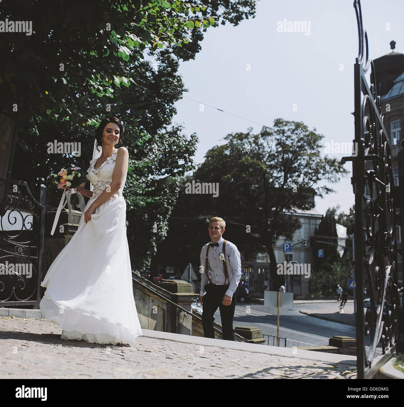 bride and groom posing on the streets Stock Photo - Alamy