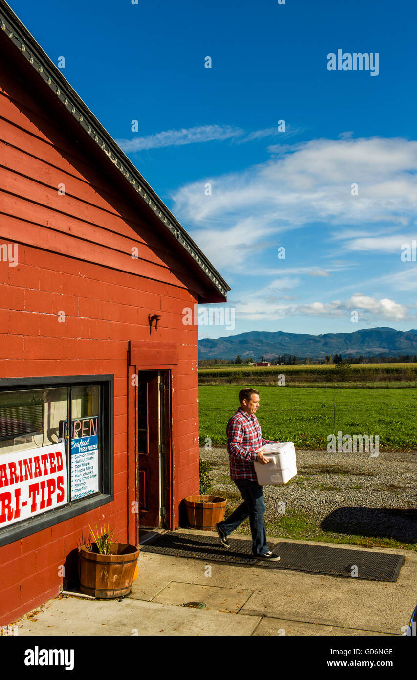 A man leaves a butcher shop in the small town of Enumclaw, Washington, USA. Stock Photo