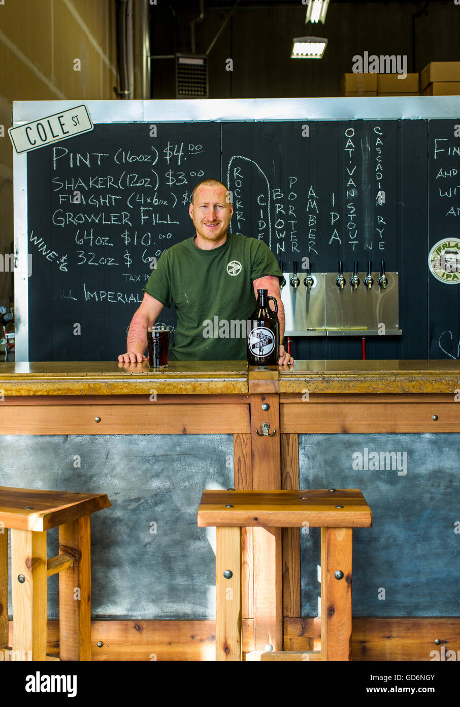 A portrait of a brewery owner behind the counter at a brewery in Enumclaw, Washington, USA. Stock Photo
