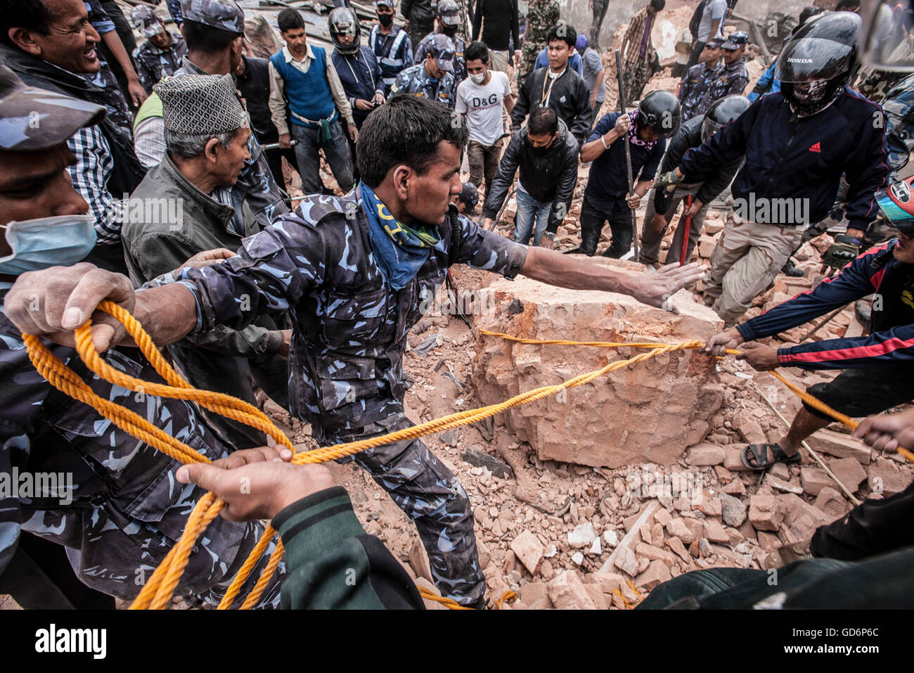 Rescuers work together  on removing rubble in an effort to recover bodies. Stock Photo