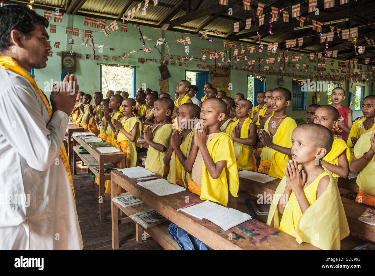 Hindu students start their regular class with prayer at Arya Gurukul. This school within Arya Samaj Temple vicinity in  Zyd was  established in 20-02-2012. All these boys are learning to become Hindu Priest. Myamnar. Stock Photo