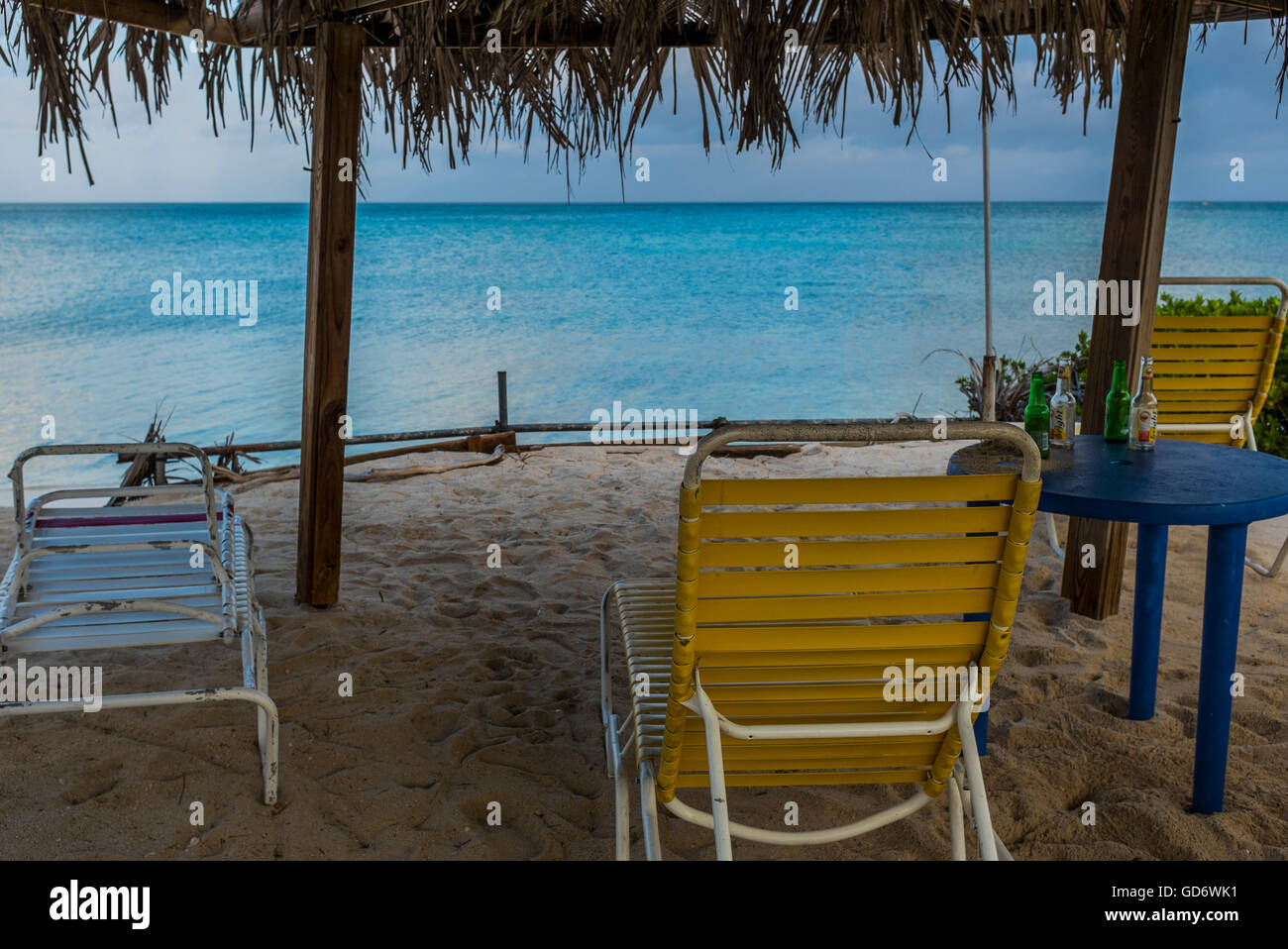 Bottle-strewn palapa in the morning light, Hadicurari Beach, Aruba. Stock Photo