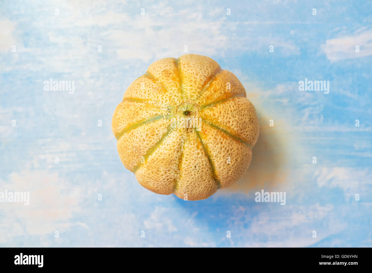 Cantaloupe melon on rustic wooden table, top view of whole fruit Stock Photo