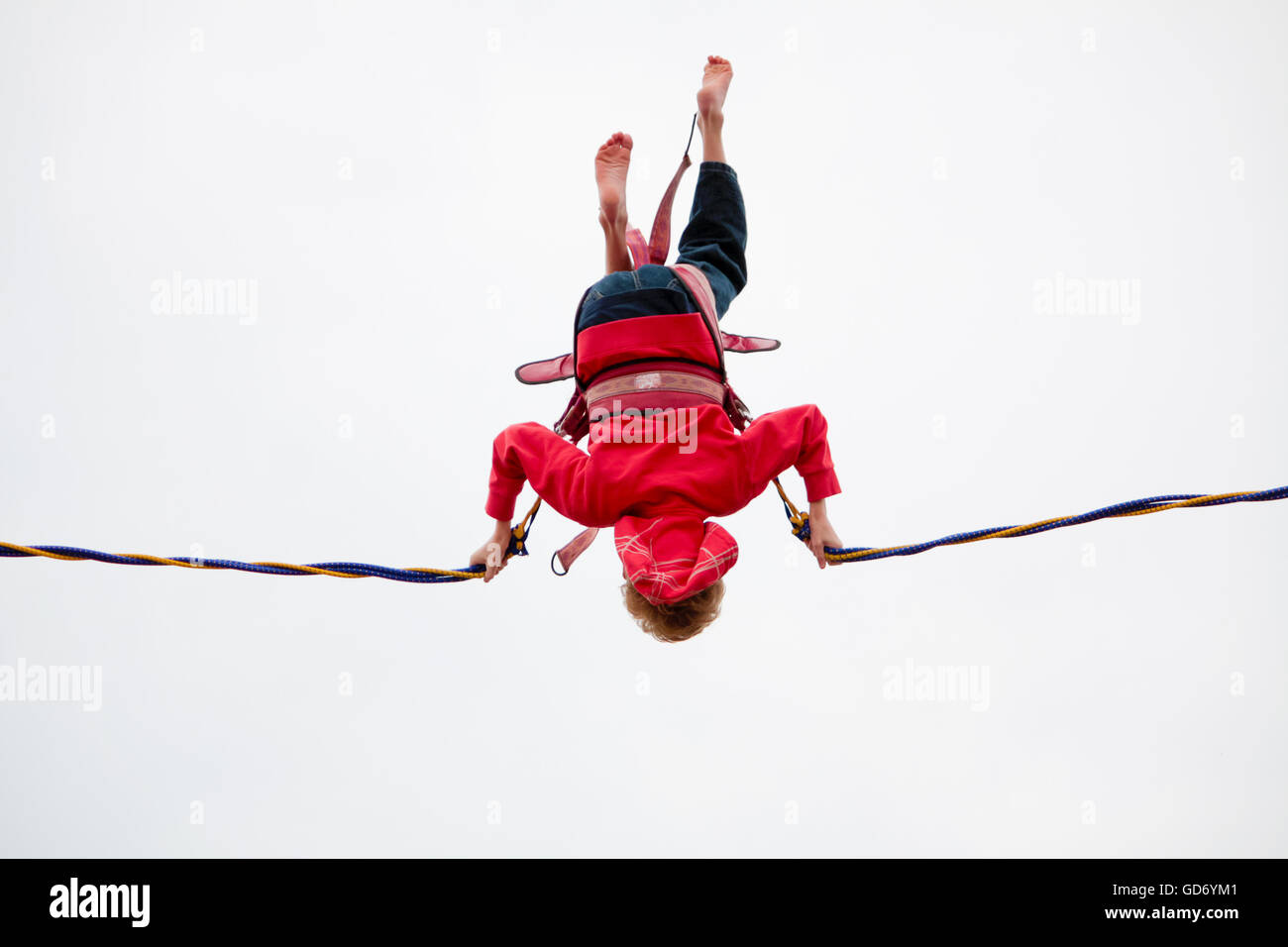 London, UK - August 15, 2010: unidentified young boy doing bungee jumping at the park. Stock Photo