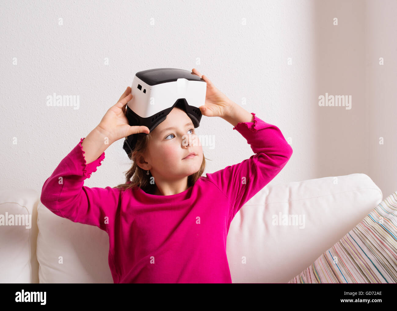 Girl wearing virtual reality goggles. Studio shot, copy space Stock Photo