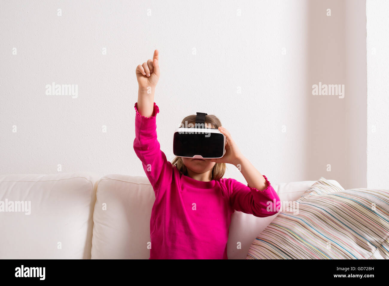 Girl wearing virtual reality goggles. Studio shot, copy space Stock Photo