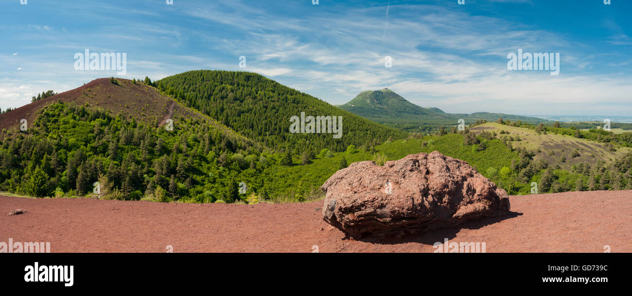 View towards Puy-de-Dome Volcano from Puy de la Vache Volcano, Auvergne, with large basaltic volcanic bomb in foreground Stock Photo