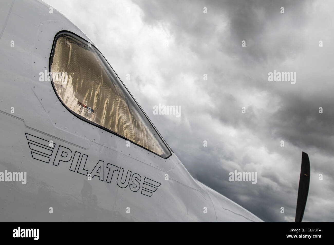 Outside shot of the cabin of a Pilatus PC-12/47 aircraft, with storm clouds overhead. Stock Photo