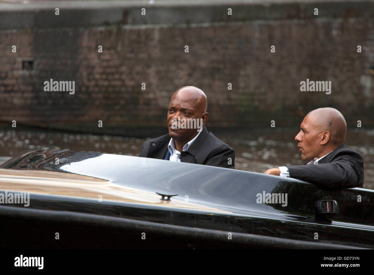 AMSTERDAM, THE NETHERLANDS ,JULY 10 2016; Famous american actor Samuel L Jackson along with a stand in actor in speedboat while Stock Photo