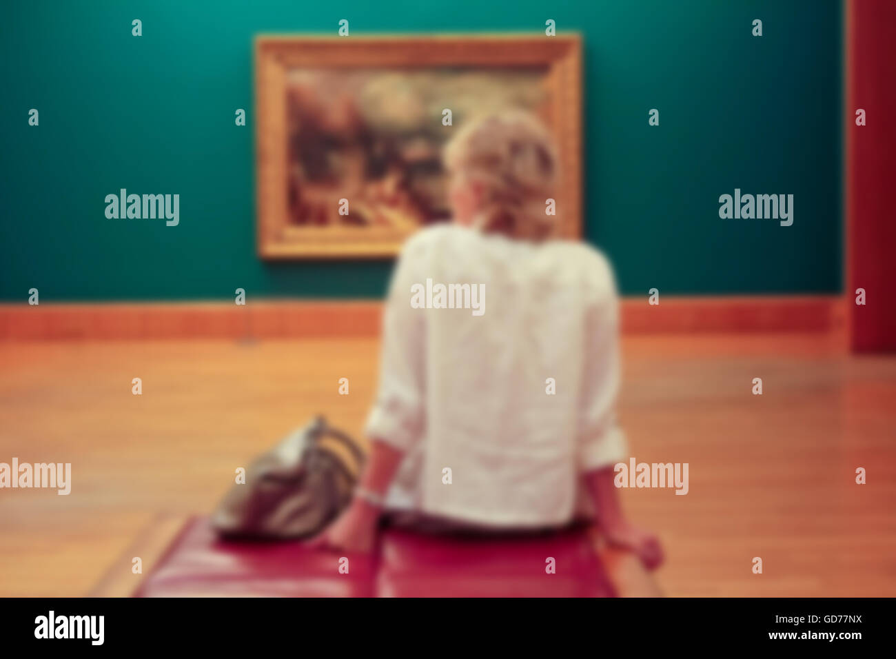 Defocused background of a woman watching art gallery. Stock Photo