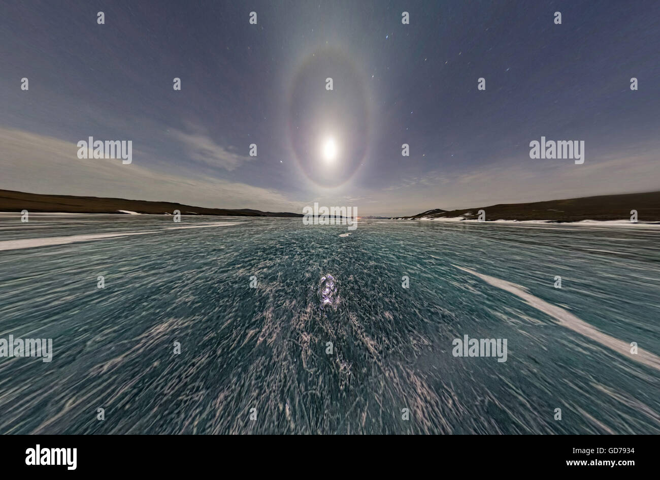 Moon halo in the night sky over Lake Baikal ice. Stereographic panorama  Little Planet Stock Photo
