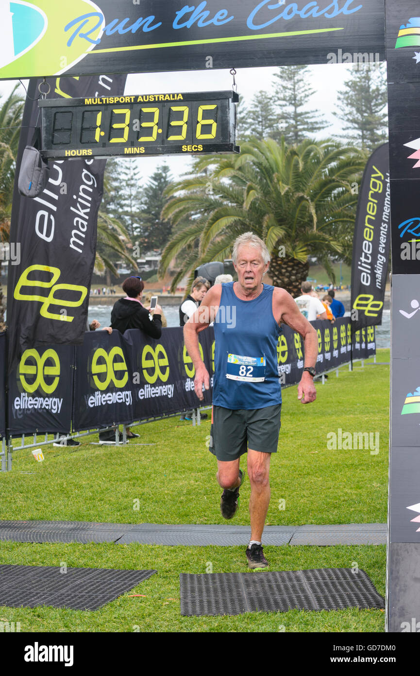 A mature man finishing the Kiama Coastal Classic Run Race, Kiama, Illawarra Coast, New South Wales, Australia Stock Photo